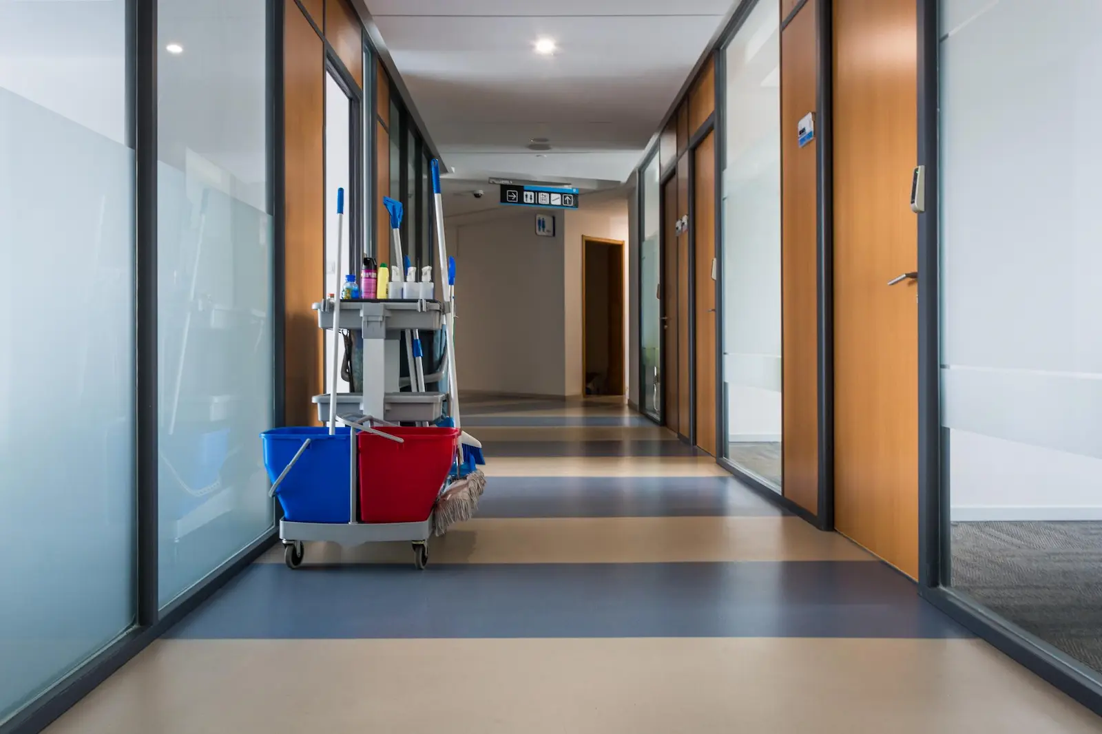 cleaner stands in the hotel corridor - Caribbean Cleaning Srq